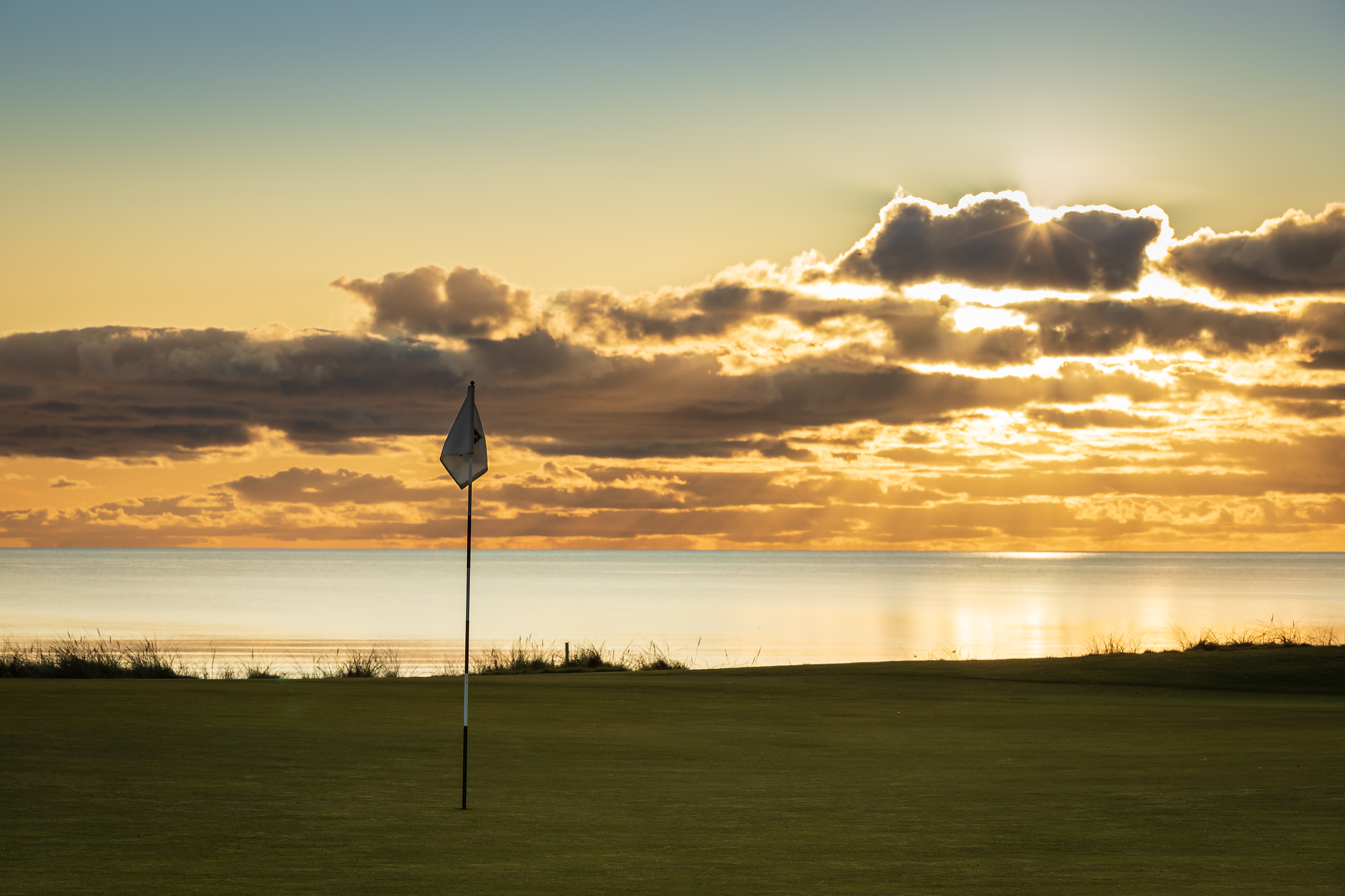 An image of the Royal Troon golf course at sunset