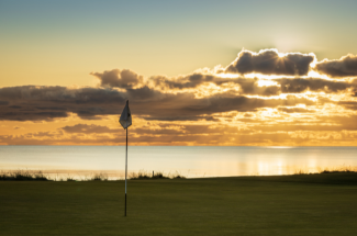 An image of the Royal Troon Golf Course at sunset 